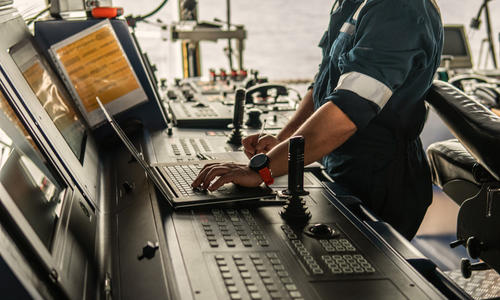 Engineer using laptop on board 